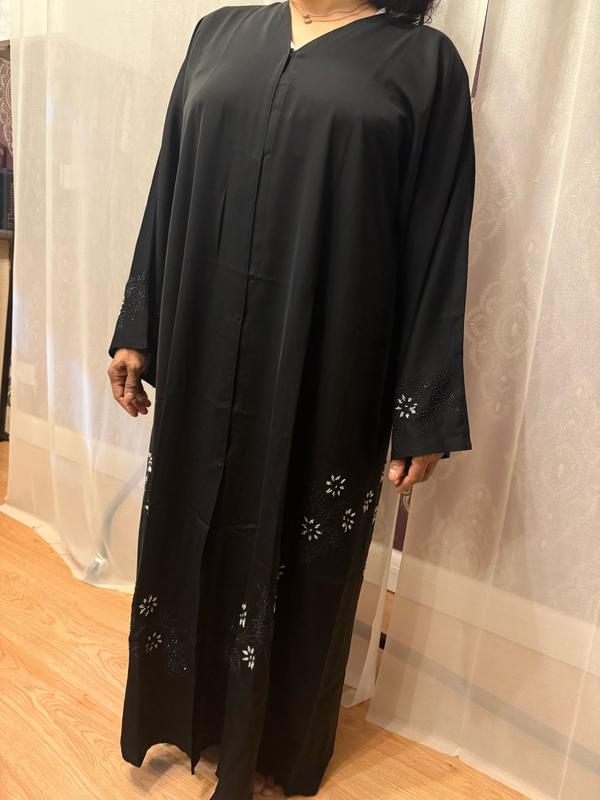 The Hadiqa Abaya - a black satiny 'Dubai' Abaya with black and hand sewn silver bead work in a flower pattern pattern and includes a chiffon hijab. 1