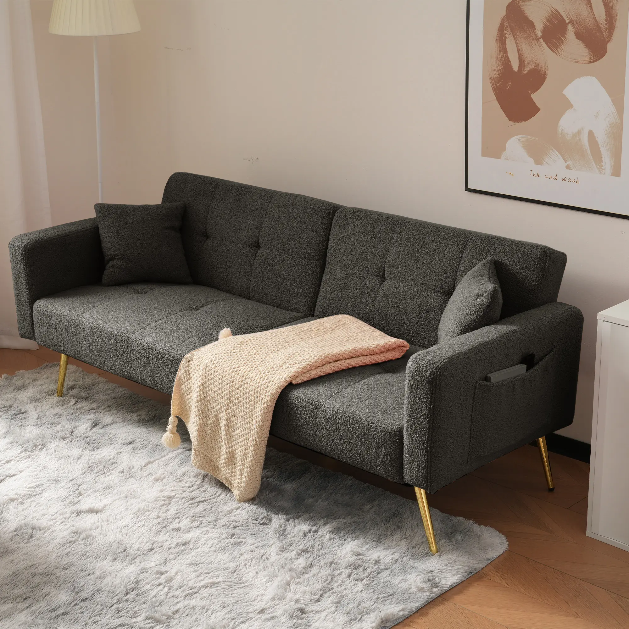The sofa bed has a bed function, three adjustable backrest angles, gold legs, cushions and side storage pockets