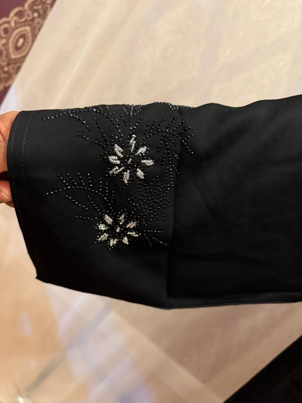 The Hadiqa Abaya - a black satiny 'Dubai' Abaya with black and hand sewn silver bead work in a flower pattern pattern and includes a chiffon hijab. 7