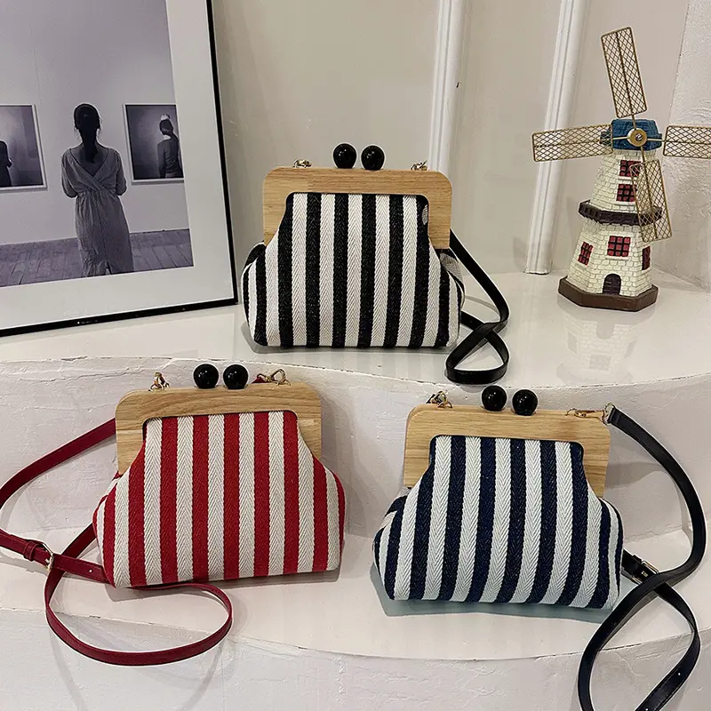 Newly launched and popular women's bag. Striped canvas clutch with wooden clip closure, stylish and delicate. Same style as influencer bags, can be used as a shoulder or crossbody bag. designer  handbags everyday  bag