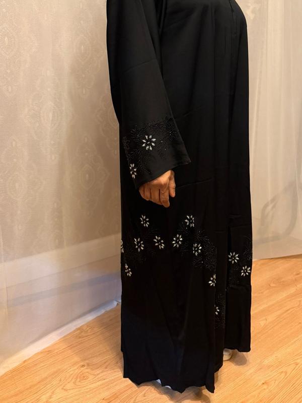 The Hadiqa Abaya - a black satiny 'Dubai' Abaya with black and hand sewn silver bead work in a flower pattern pattern and includes a chiffon hijab. 3