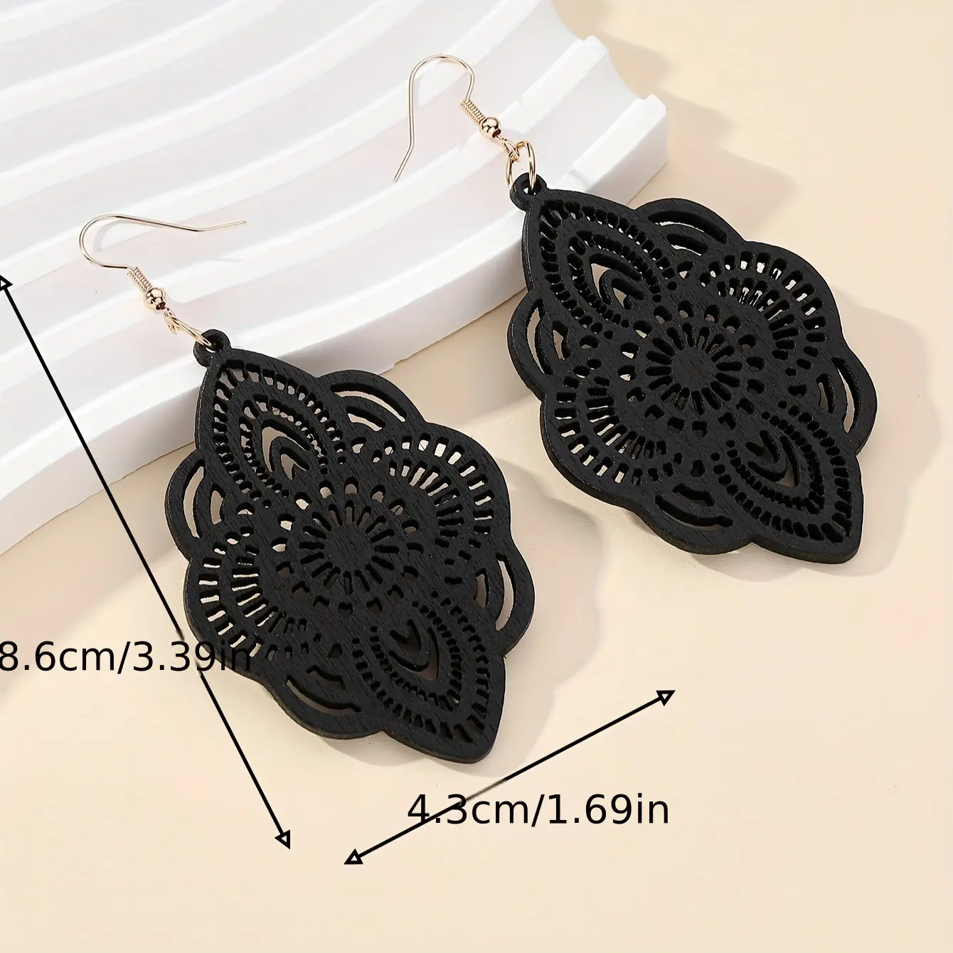 Delicate black wood floral cutouts with gold hooks, perfect for everyday or holiday wear, lovely earrings