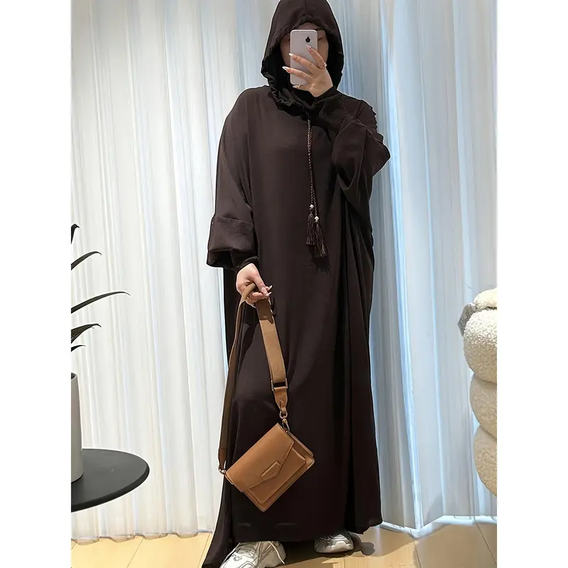 A Plain, Loose-Fitting Hooded Long Tunic for Ramadan, Featuring Elegant Batwing Sleeves, Designed for Women. 7