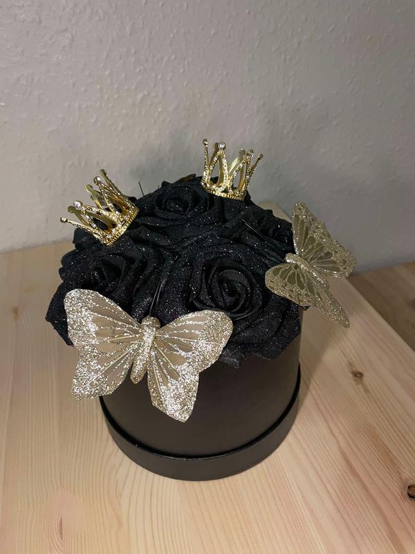 Artificial small black and gold glittered hat box arrangement with roses small crown and gold butterflies bespoke arrangement 1