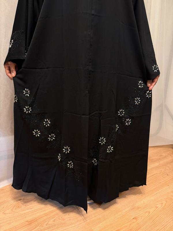 The Hadiqa Abaya - a black satiny 'Dubai' Abaya with black and hand sewn silver bead work in a flower pattern pattern and includes a chiffon hijab. 2
