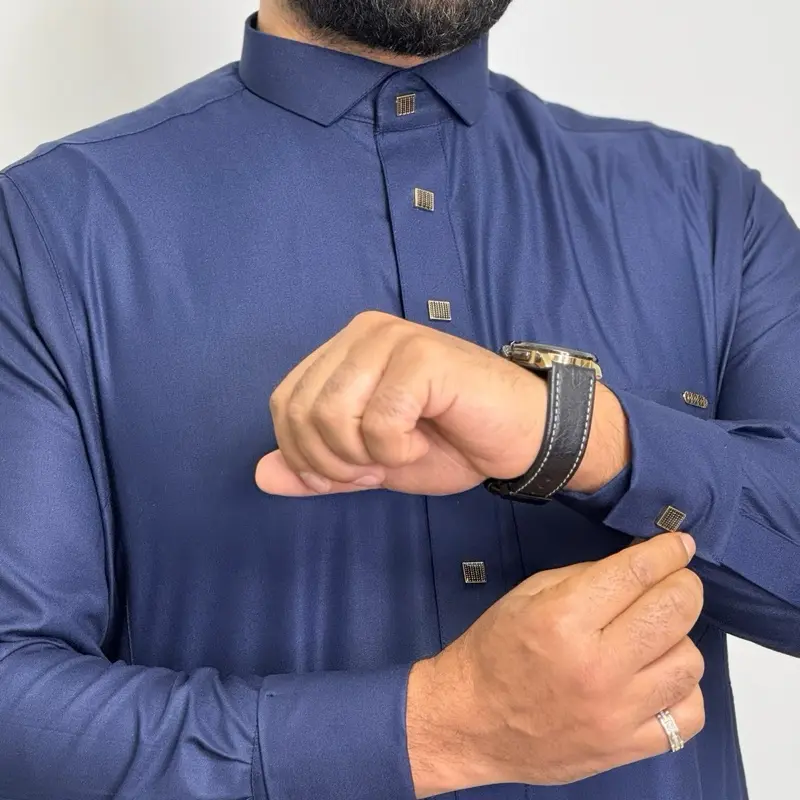 Navy Blue Saudi Premium Thobe for Men - Indulgent Fabric, Breast Pocket & Two Side Pockets with yellow metal buttons.