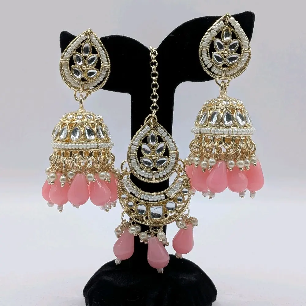 Gold tone traditional kundan and pearl jhumki earrings and tikka