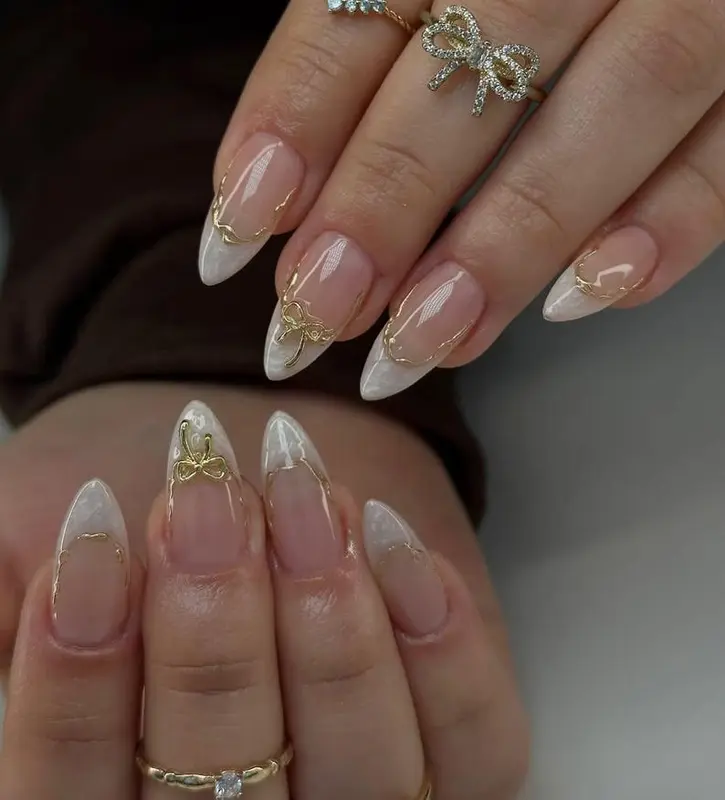 Handmade Soft Gel French Tips – Long-Lasting Reusable Luxury Milky White Marble Nails with Gold Bow Charms & Elegant Stiletto Design 2